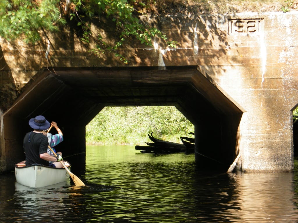 canoeing under a bridge