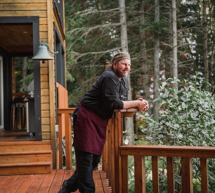 Greg Waters posing by the pizza oven