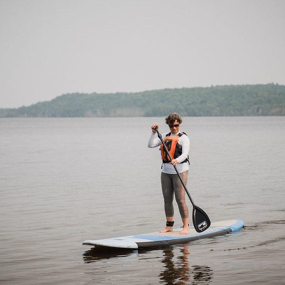 Trae on a paddle board