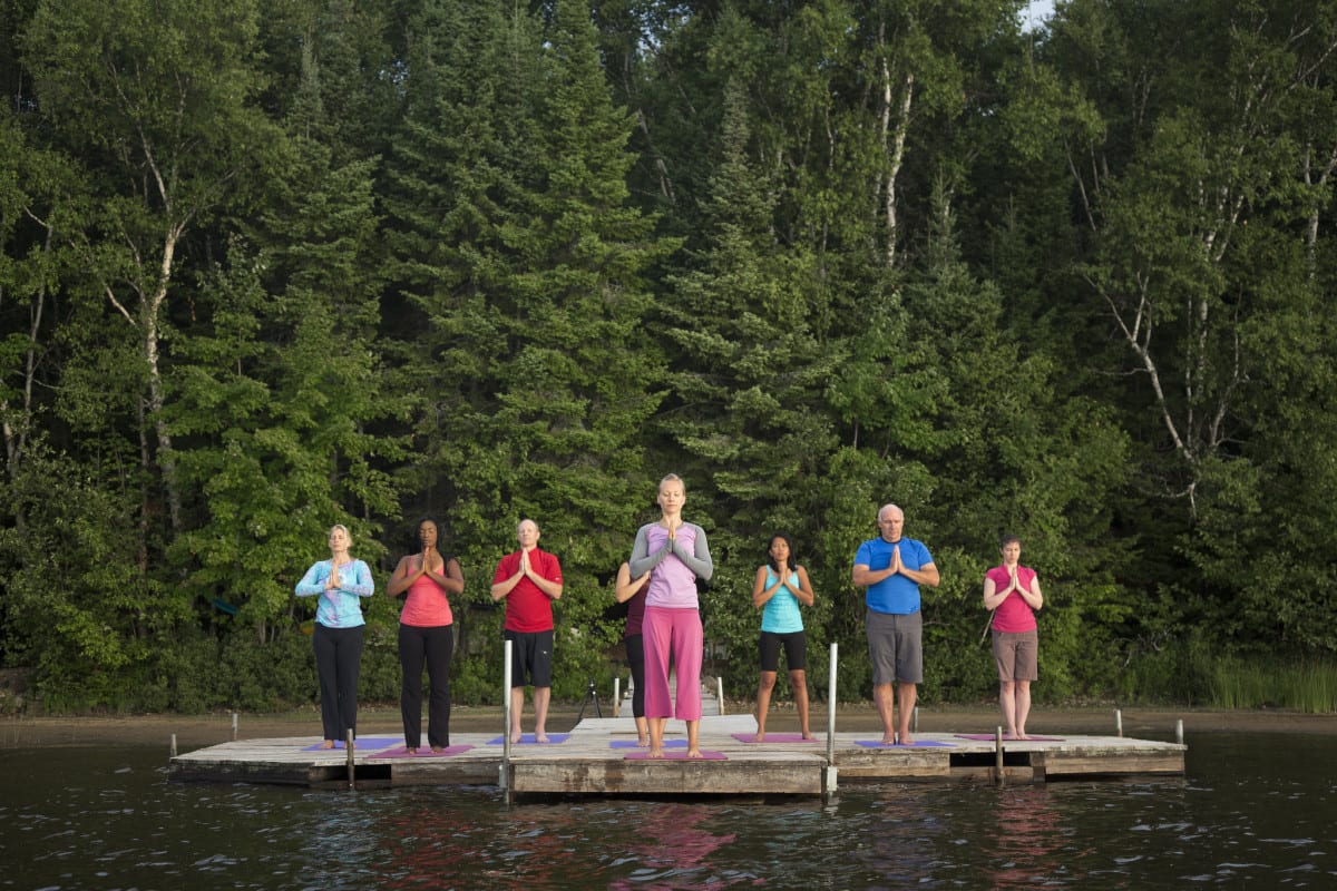 yoga on floating platform lake, trees